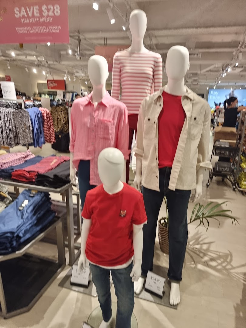Mannequins display stylish casual wear for adults and children inside Marks & Spencer.