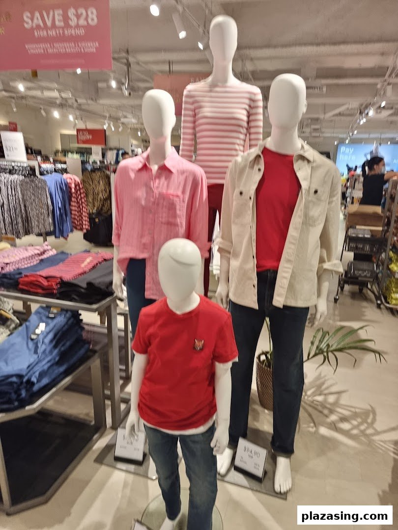 Mannequins display stylish casual wear for adults and children inside Marks & Spencer.