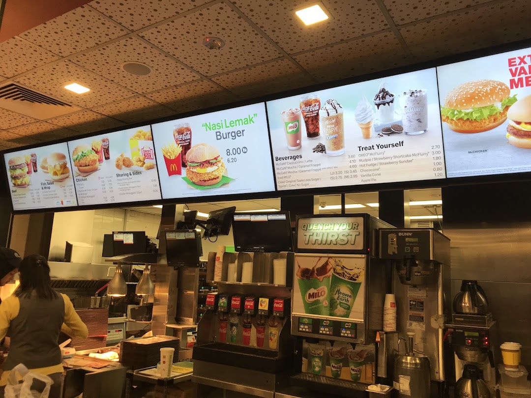 Digital menu boards at McDonald's, showcasing a variety of burgers, beverages, and desserts.