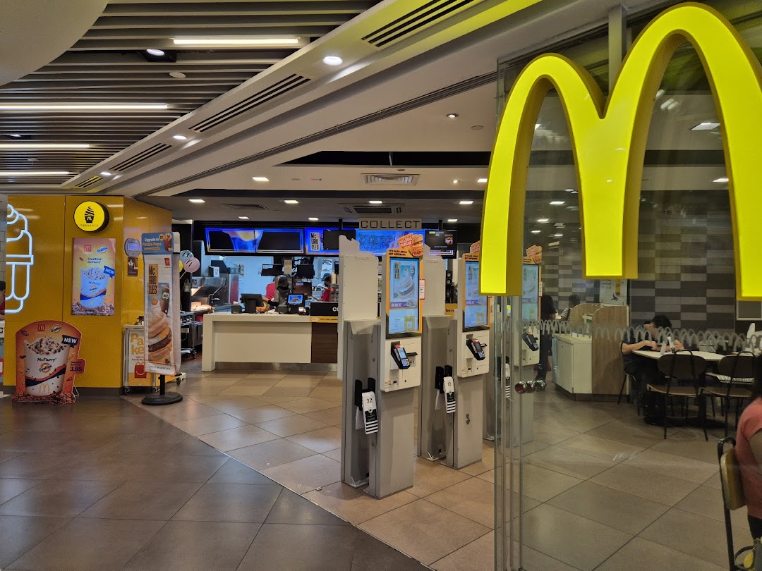 Interior view of McDonalds Plaza Singapura, showing self-service kiosks and order counter.