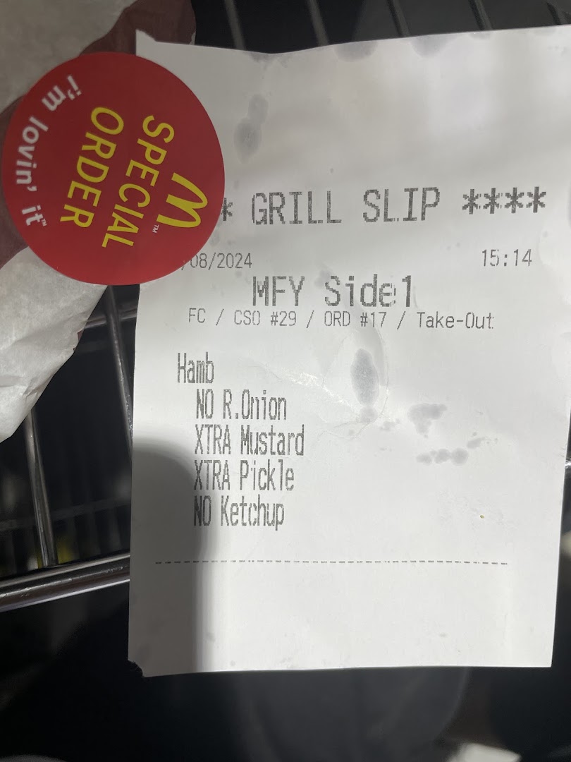 A McDonald's special order sticker and a grill slip showing a customized hamburger order.