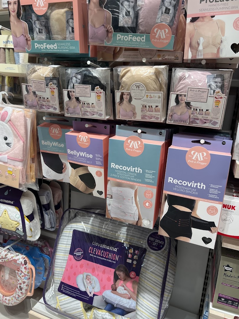 A display of maternity and baby products, including nursing bras, support belts, and nursing pillows.