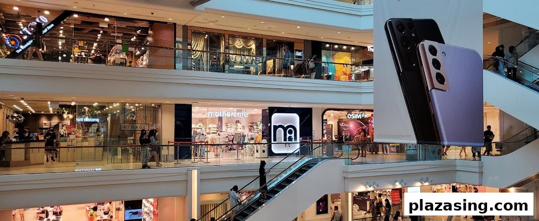 Interior view of Plaza Singapura mall, featuring Mothercare and other retail stores with shoppers and escalators.