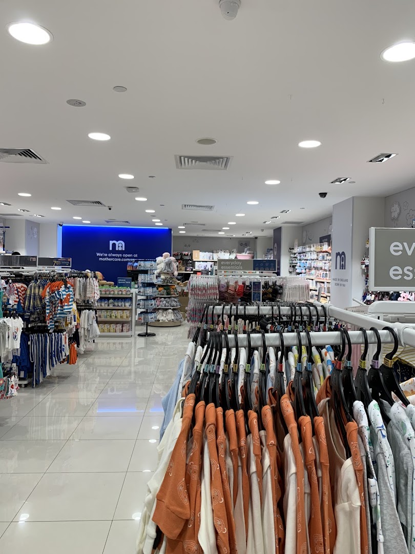 An interior view of Mothercare, showcasing racks of baby and children's clothing and essentials.