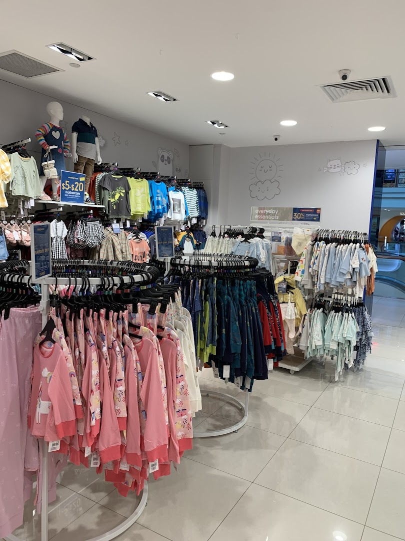 Interior view of Mothercare, showcasing racks of colorful children's clothing and baby essentials.