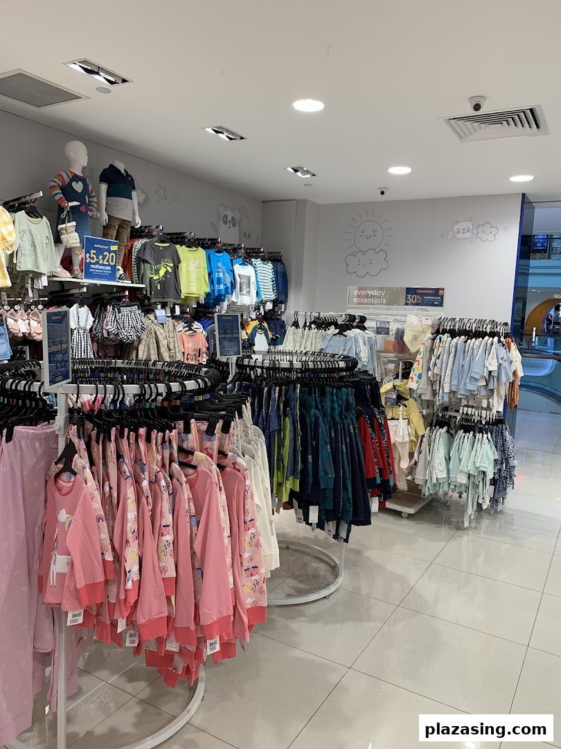 Interior view of Mothercare, showcasing racks of colorful children's clothing and baby essentials.