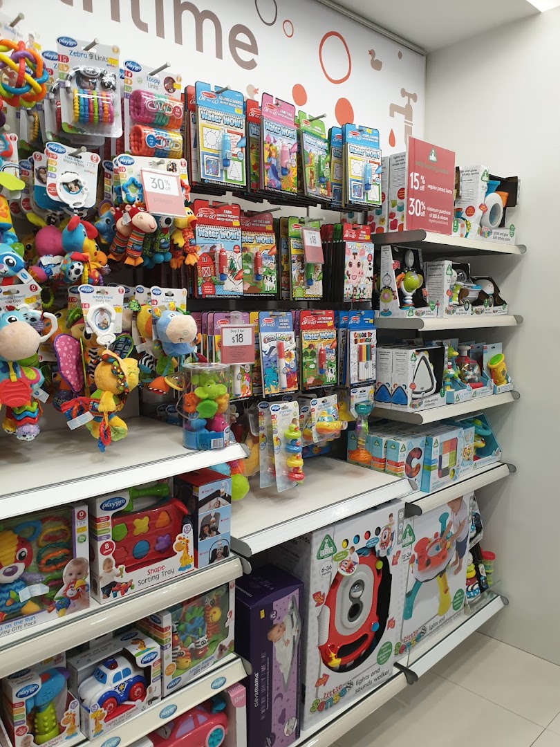 A vibrant display of baby toys, educational items, and accessories on shelves inside Mothercare.