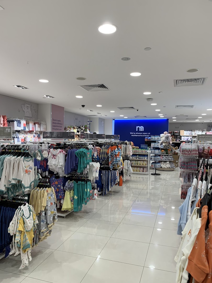 Interior view of Mothercare, showcasing racks of baby and children's clothing and essential products.