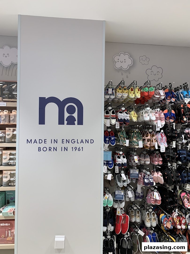 An interior shot of Mothercare, featuring a brand sign and a colorful display of children's footwear.