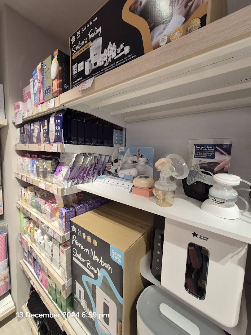 Shelves stocked with baby feeding and sterilizing products, including breast pumps and bundles, at Mothercare.