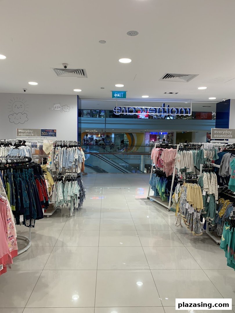 Interior view of Mothercare, showcasing baby and children's clothing racks leading to the mall entrance.