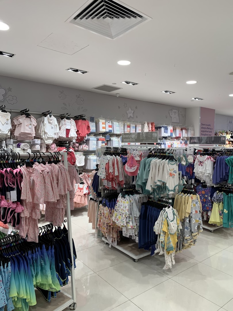 An interior view of Mothercare, showcasing a wide array of baby and children's clothing and essentials.
