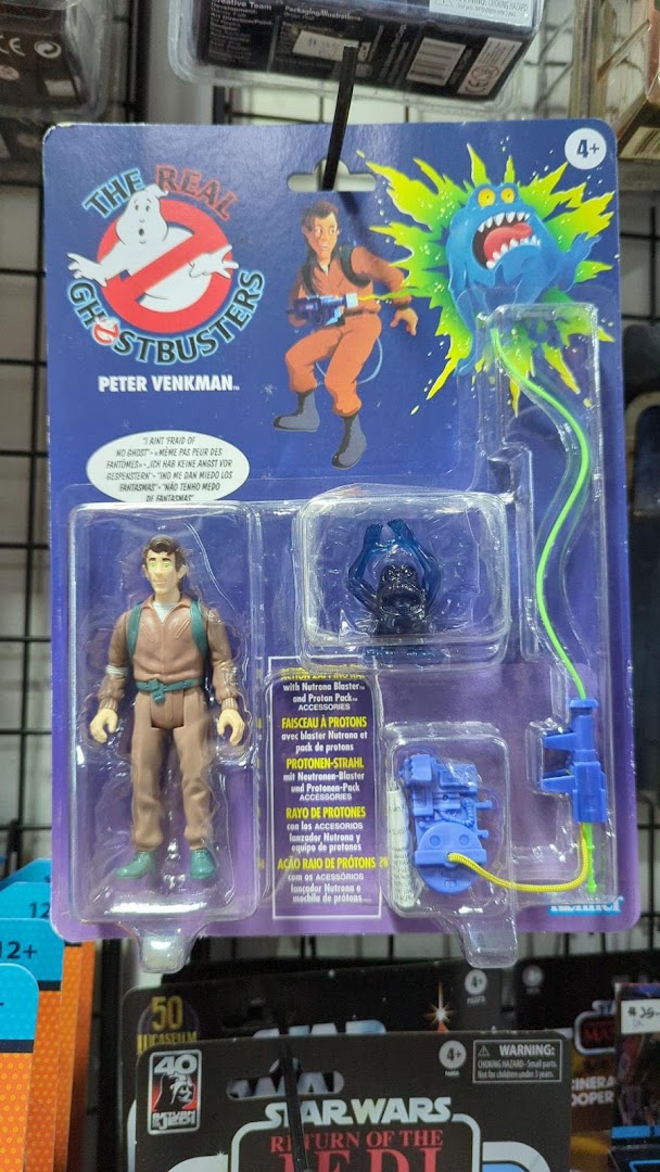 A packaged 'The Real Ghostbusters' Peter Venkman action figure displayed in a retail shop.