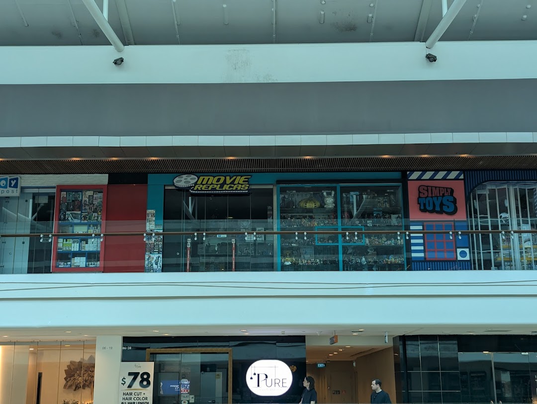 The shop front of Movie Replicas Collection and Simply Toys, viewed from across a mall level.