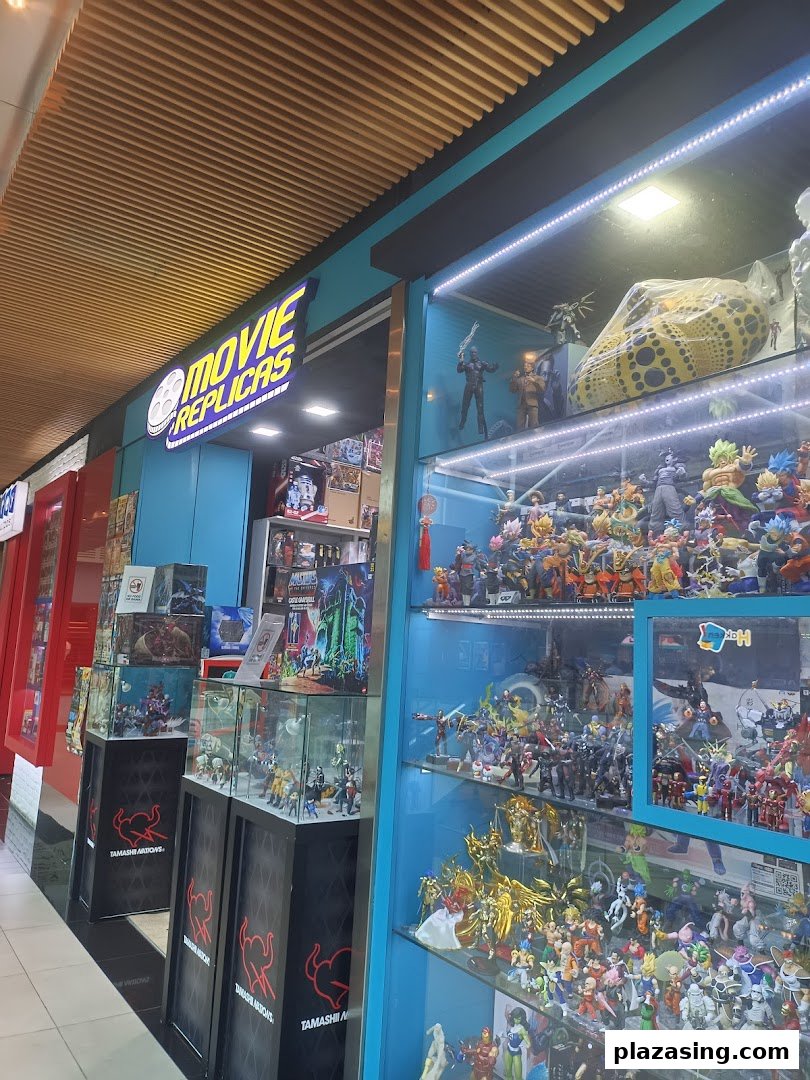 Exterior view of Movie Replicas Collection shop, showcasing various action figures and collectibles in display cases.