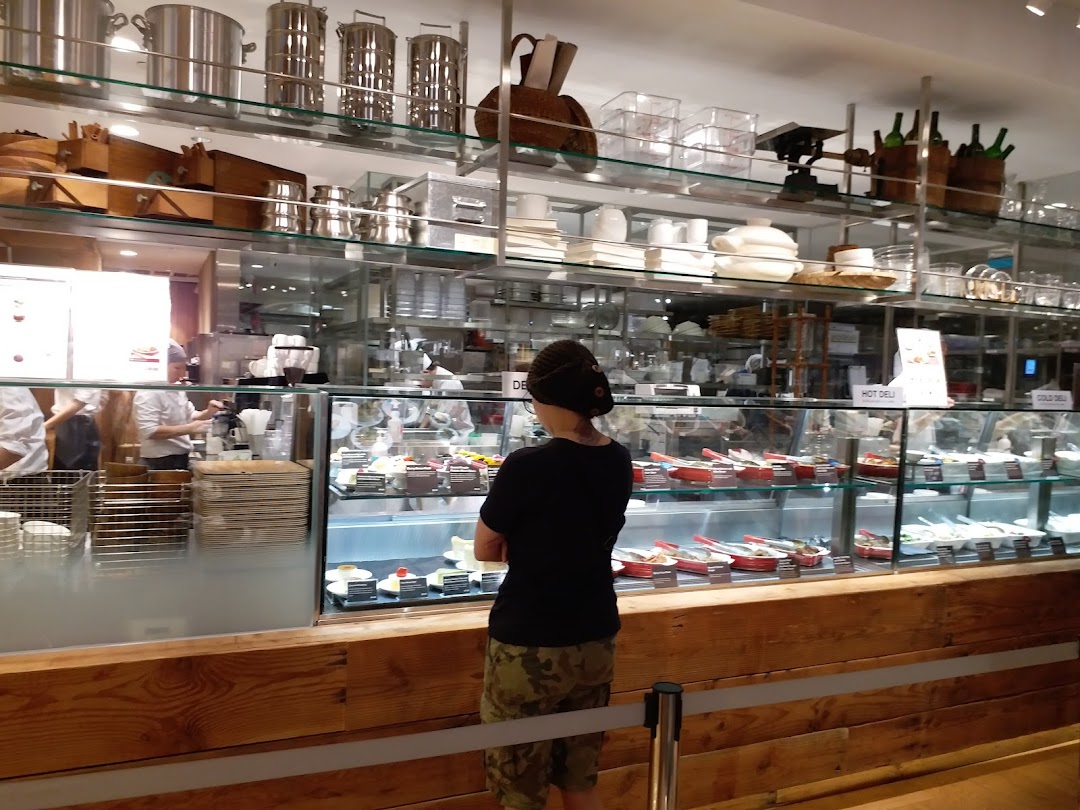 A customer views the hot and cold deli food display at MUJI's in-store cafe.