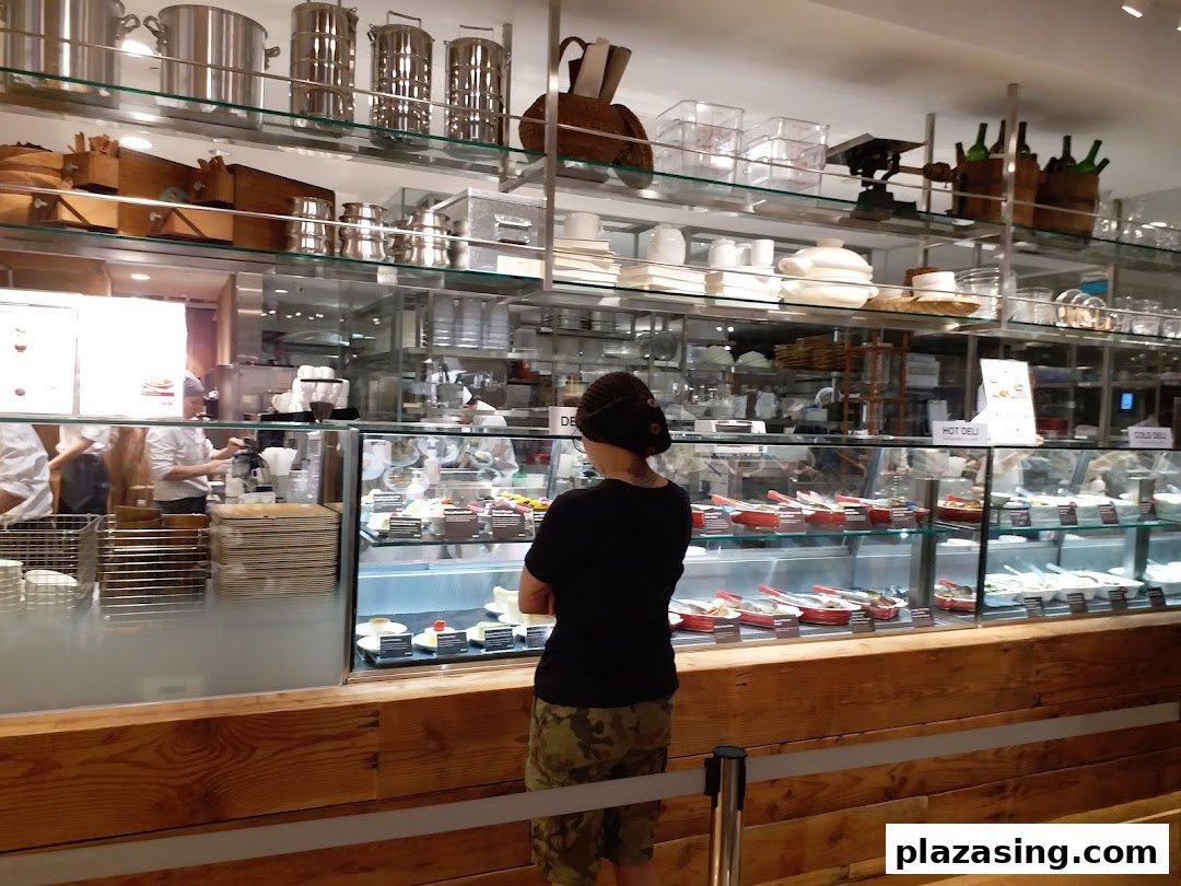 A customer views the hot and cold deli food display at MUJI's in-store cafe.
