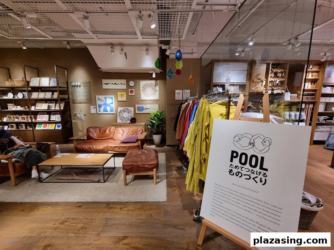 A cozy interior view of MUJI, showcasing furniture, home goods, and apparel displays.