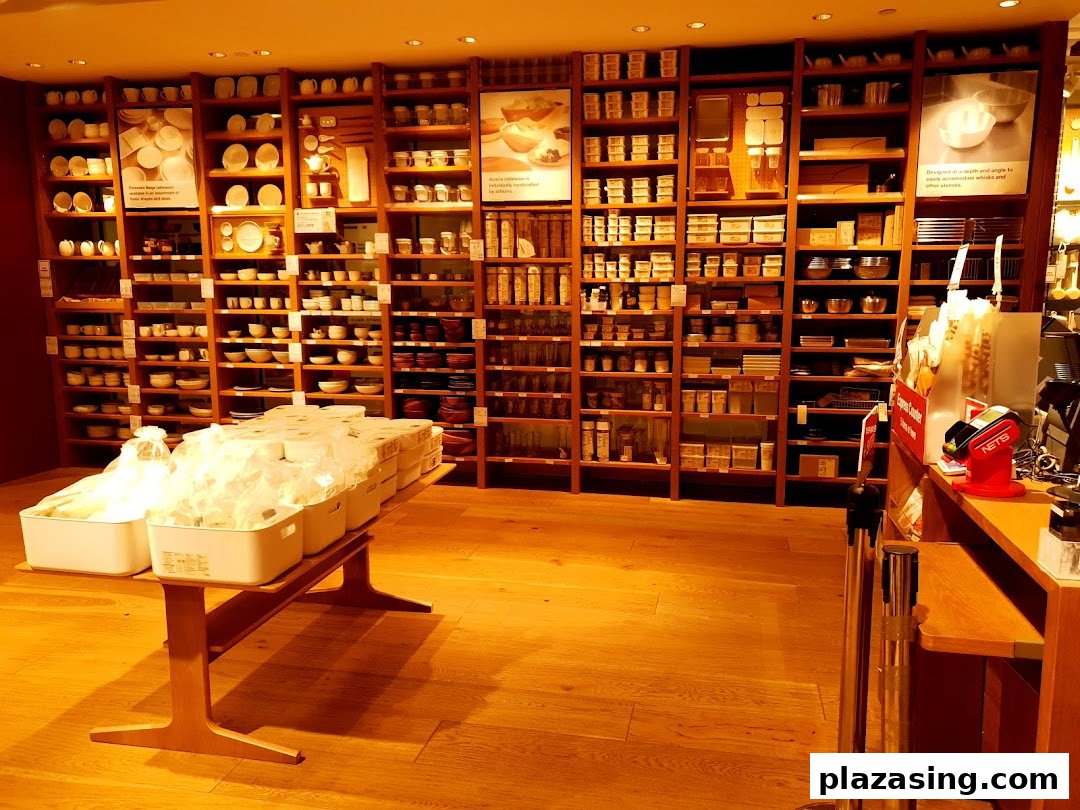 Interior view of MUJI showcasing extensive wooden shelves filled with household goods and kitchenware.