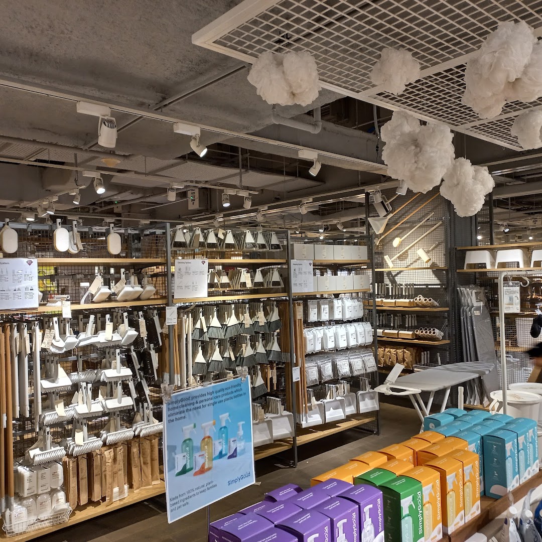 An aisle in MUJI showcasing a wide range of home cleaning tools and eco-friendly products.
