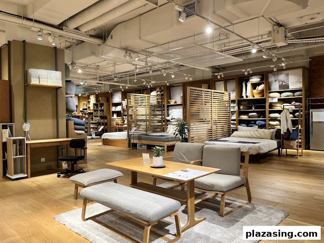 An interior view of MUJI showcasing minimalist furniture, bedding, and home essentials in a warm, inviting setting.