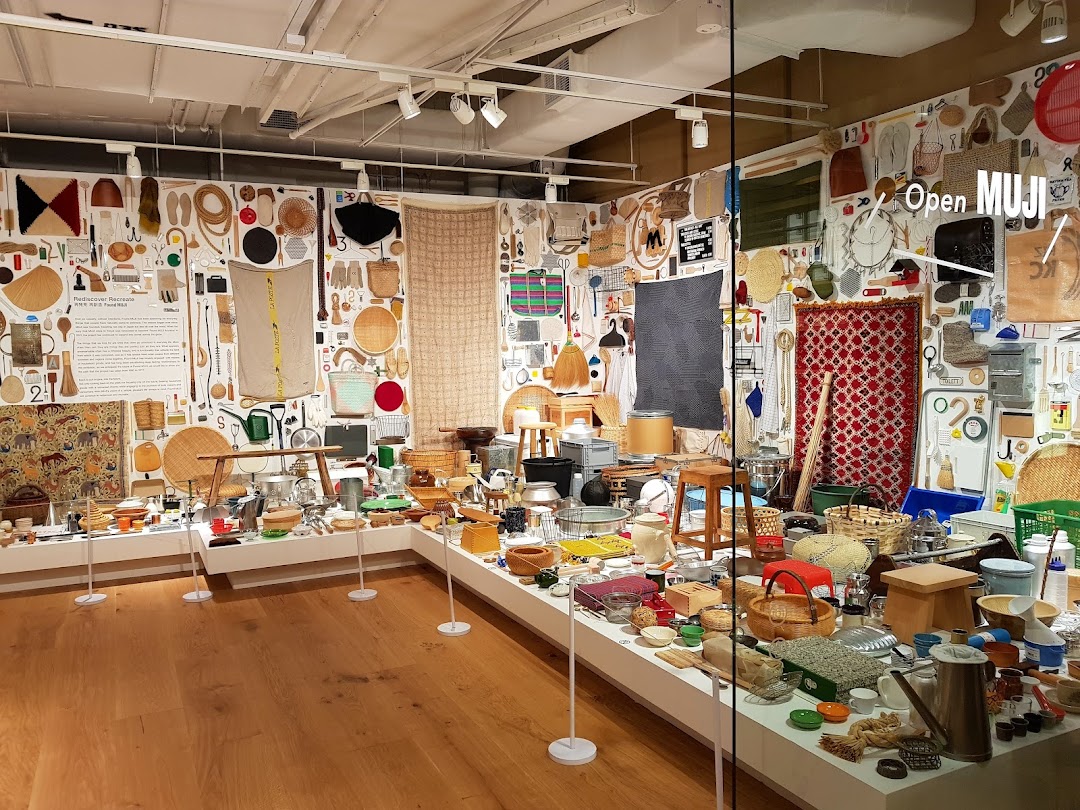 An interior view of MUJI showcasing a unique exhibition of diverse everyday objects and traditional crafts.
