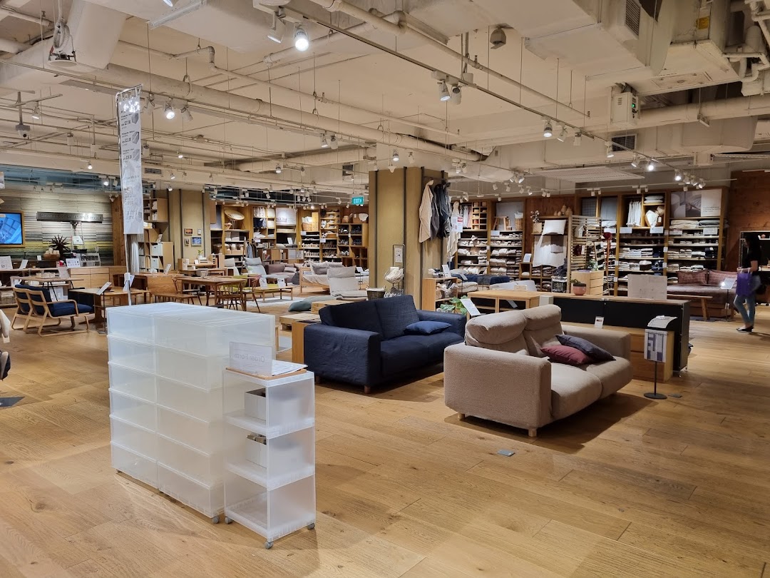 Interior view of MUJI store showcasing furniture, home goods, and storage solutions in a spacious layout.