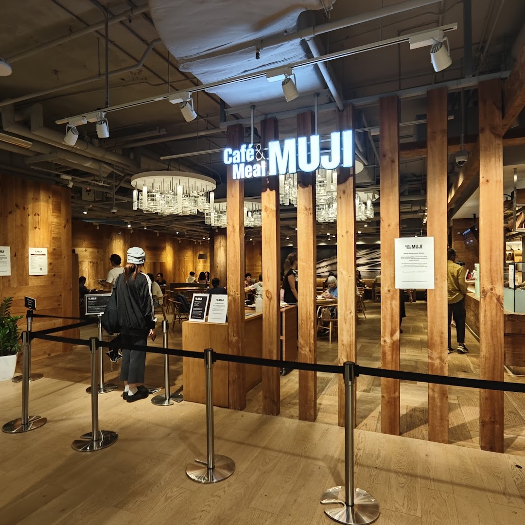 Entrance to Cafe & Meal MUJI, featuring a warm wooden interior and dining area.