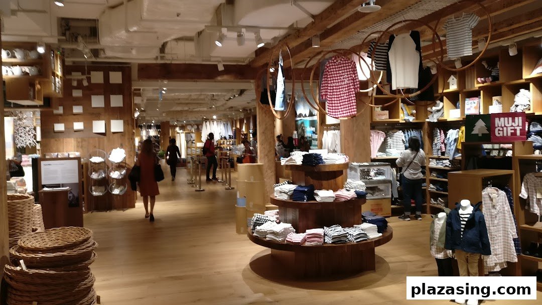 Interior view of MUJI Plaza Singapura, showcasing clothing, home goods, and customers browsing products.