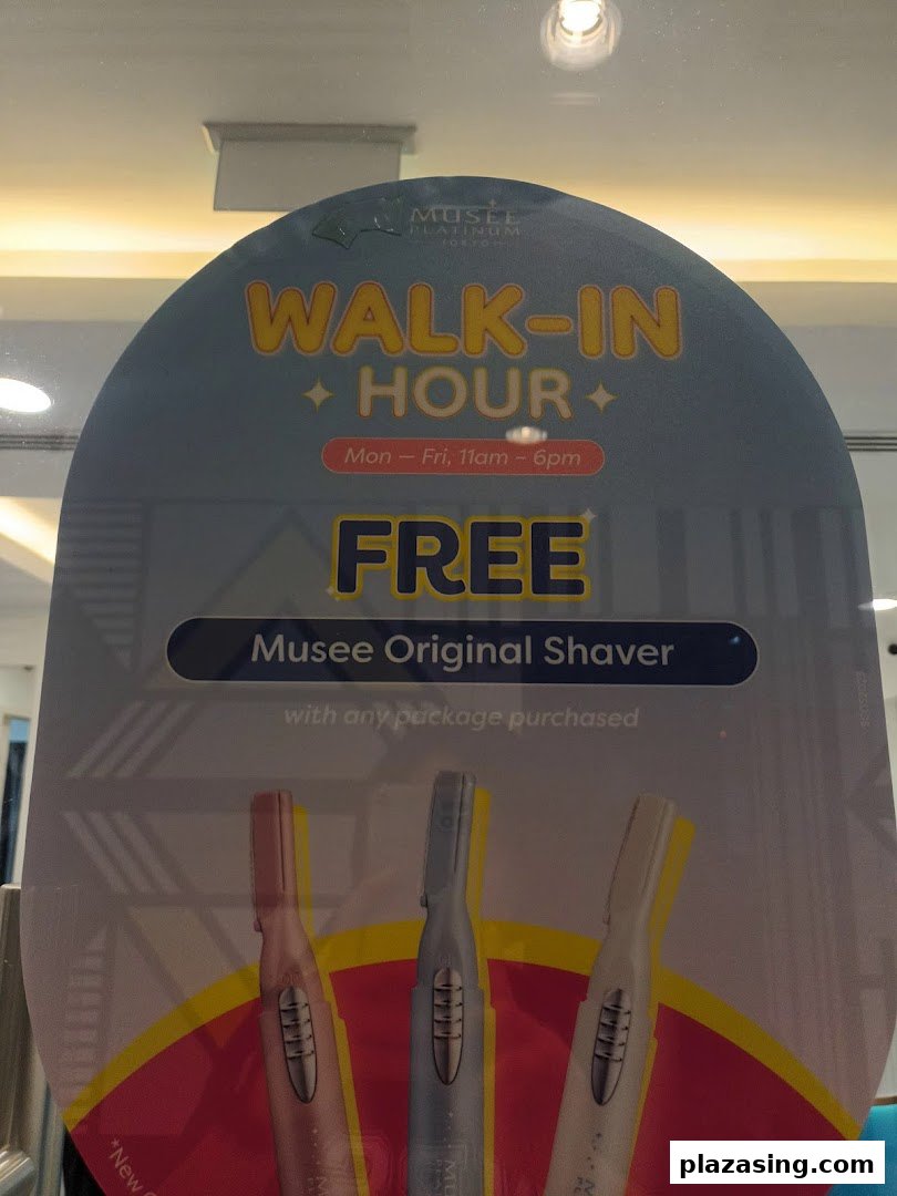 A promotional sign for Musee Platinum Tokyo advertising a 'Walk-In Hour' with a free shaver upon package purchase.