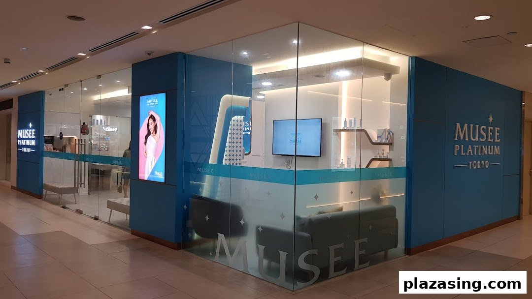 The bright, modern storefront of Musee Platinum Tokyo, featuring glass walls and blue accents.