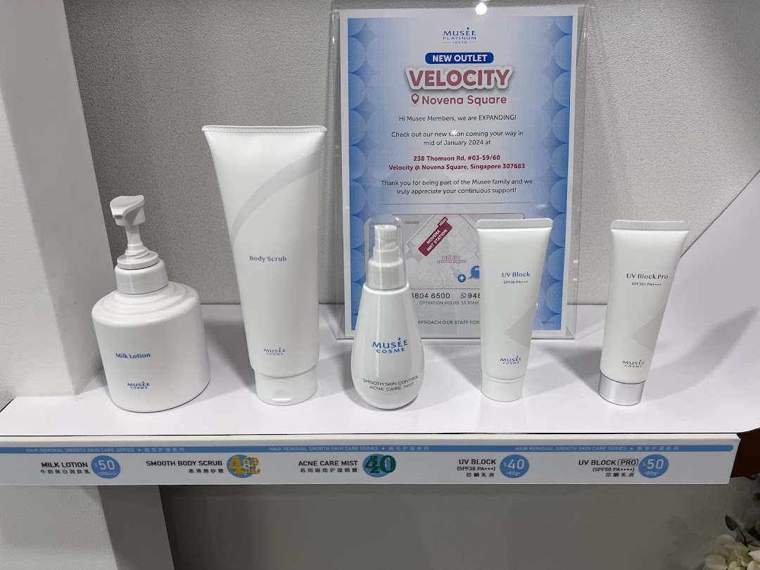 A display of Musee Platinum Tokyo skincare products and a promotional poster for their new Velocity outlet.