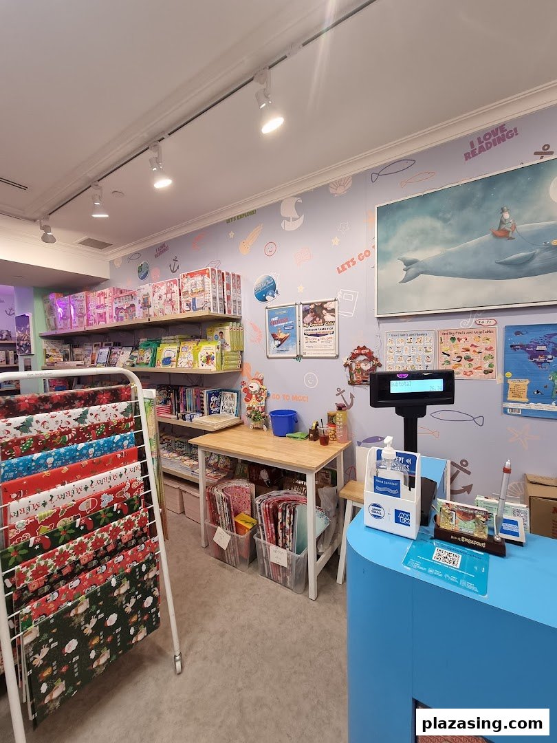Interior view of My Greatest Child Plaza Singapura, featuring books, educational toys, gift wrap, and a checkout counter.