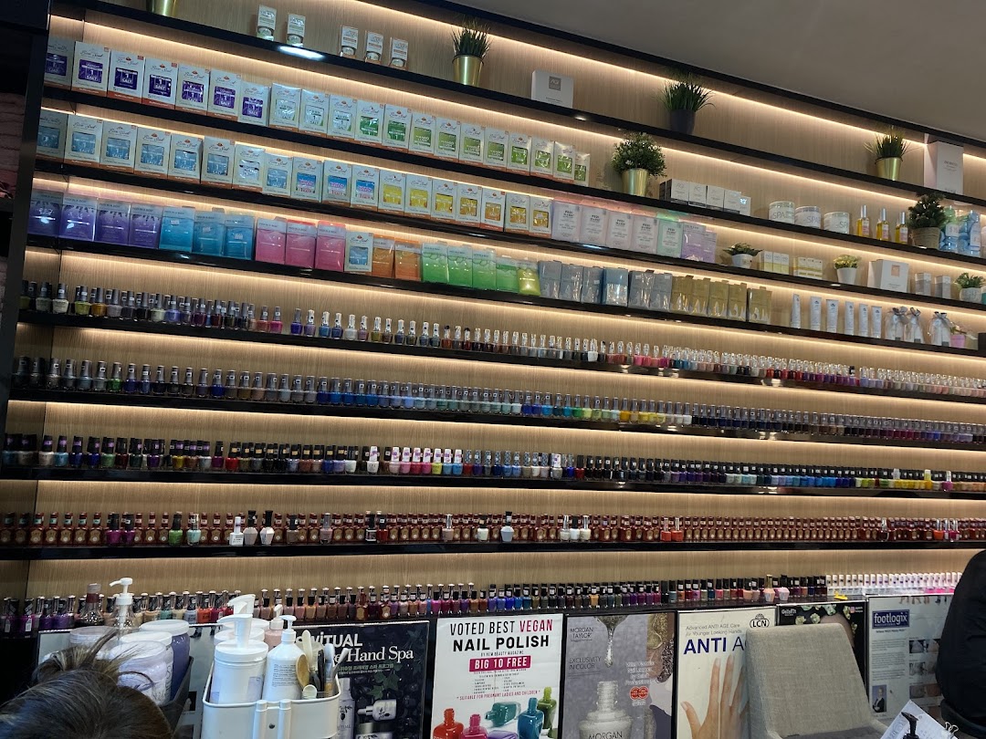 A vibrant wall display showcasing a vast collection of nail polishes and spa products at N20 Nail Spa.