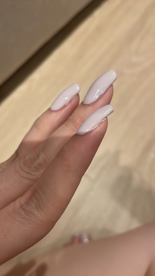 Close-up of a hand showcasing elegant light pink manicured nails.
