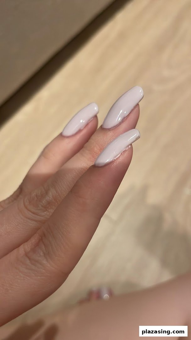 Close-up of a hand showcasing elegant light pink manicured nails.