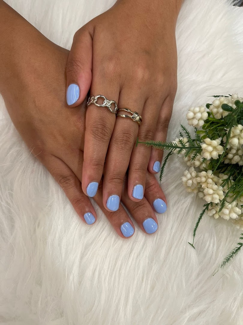 Hands with fresh light blue nail polish, showcasing a perfect manicure on a soft white background.