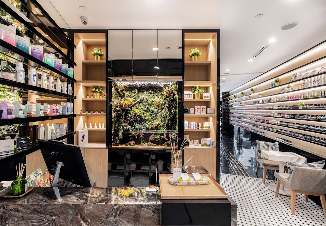 Modern and well-lit interior of N20 Nail Spa, featuring extensive product displays, a reception counter, and comfortable seating.