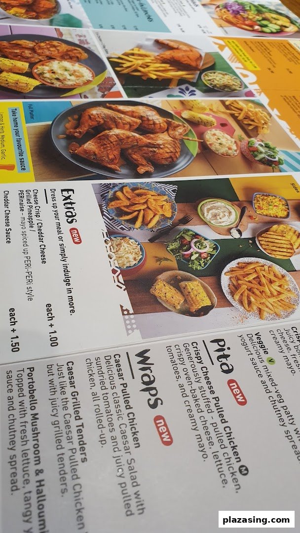A close-up view of Nando's menu, showcasing PERi-PERi chicken dishes, wraps, pitas, and sides.