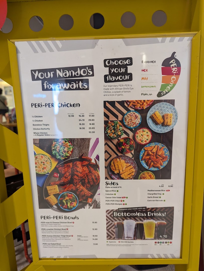 A vibrant Nando's menu board showcasing PERi-PERi chicken, bowls, sides, and bottomless drinks.