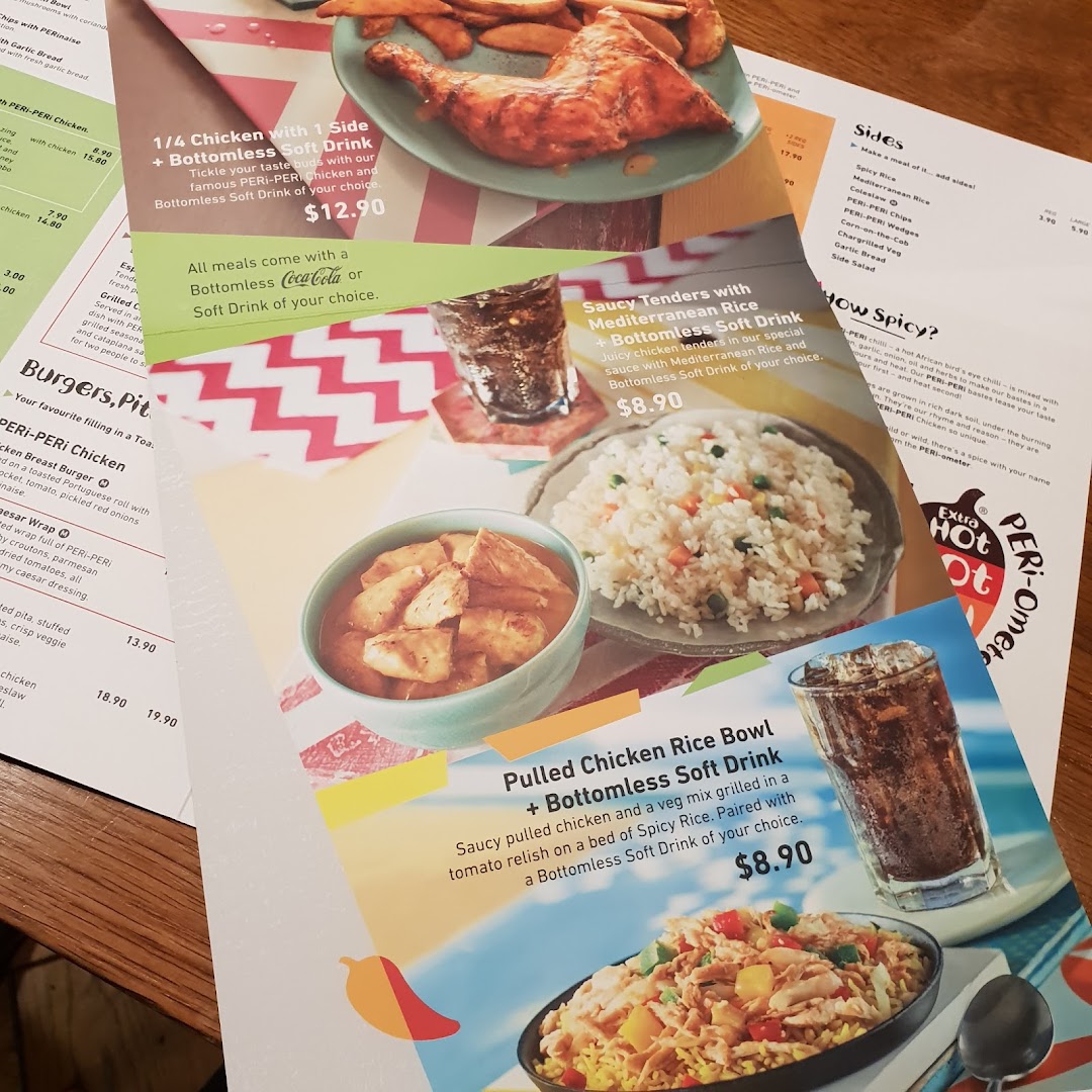 A close-up view of a Nando's menu displaying chicken meals, sides, and combo offers with prices.