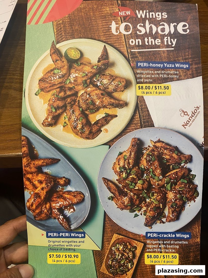 A close-up of a Nando's menu showcasing various flame-grilled chicken wing options.