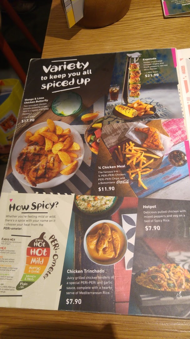 A Nando's menu displaying various flame-grilled PERi-PERi chicken dishes and spice levels.