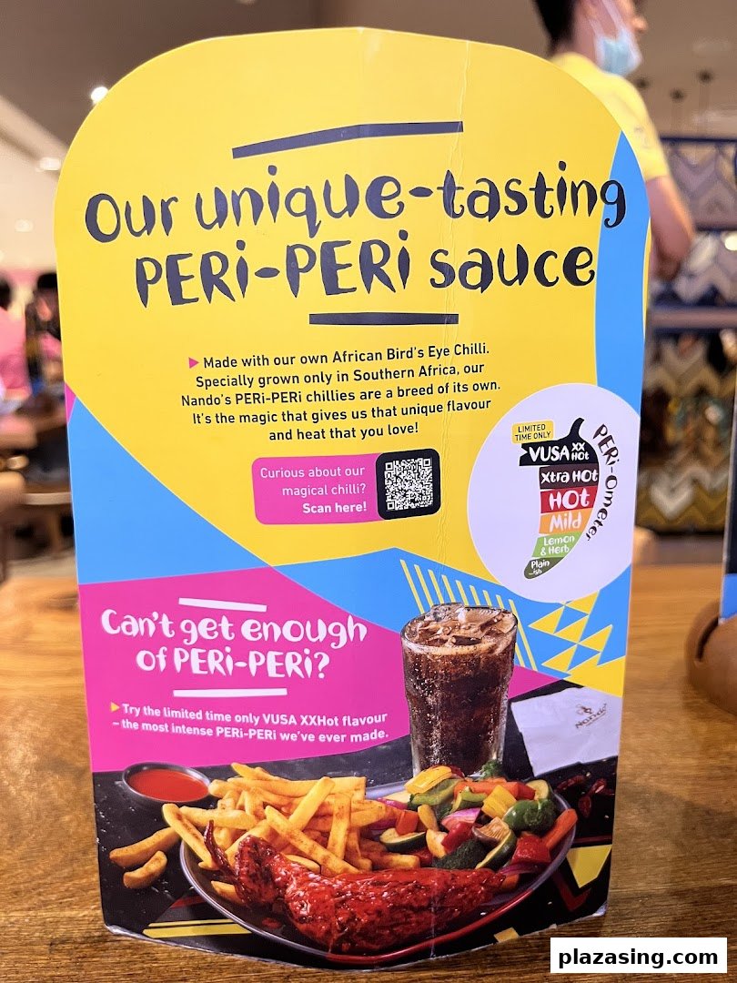 A Nando's table display promoting their unique PERi-PERi sauce and the new VUSA XXHot flavor.