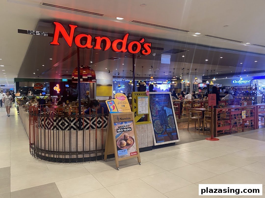 The vibrant Nando's restaurant entrance with its iconic red signage and inviting interior.
