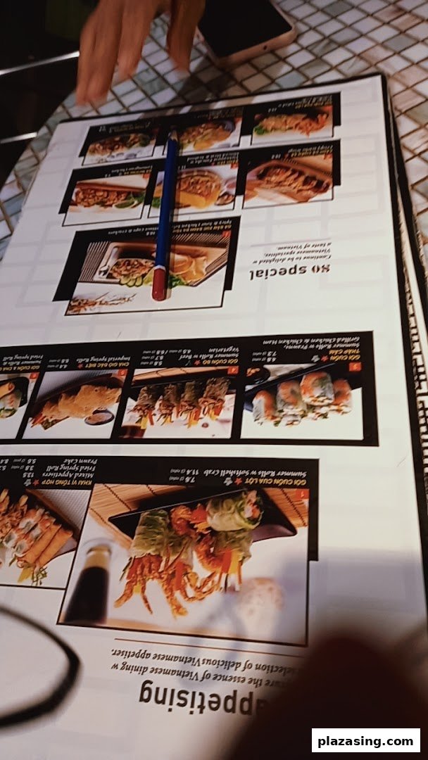 A close-up view of a Vietnamese restaurant menu displaying various appetisers and rolls.