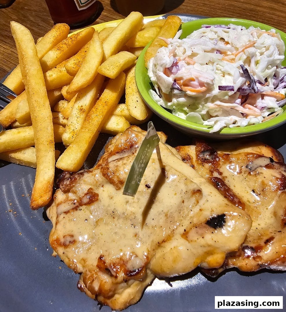 A delicious Nando's meal featuring flame-grilled chicken, crispy fries, and fresh coleslaw.