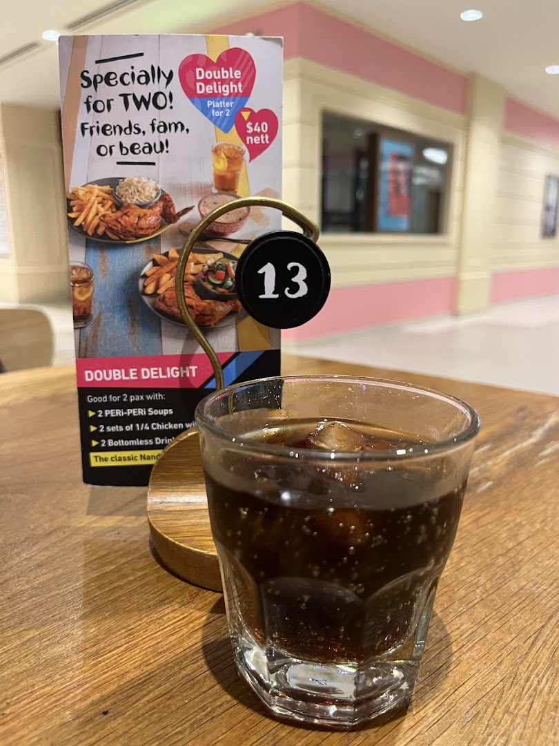 A Nando's table tent promoting the 'Double Delight' platter with a drink.