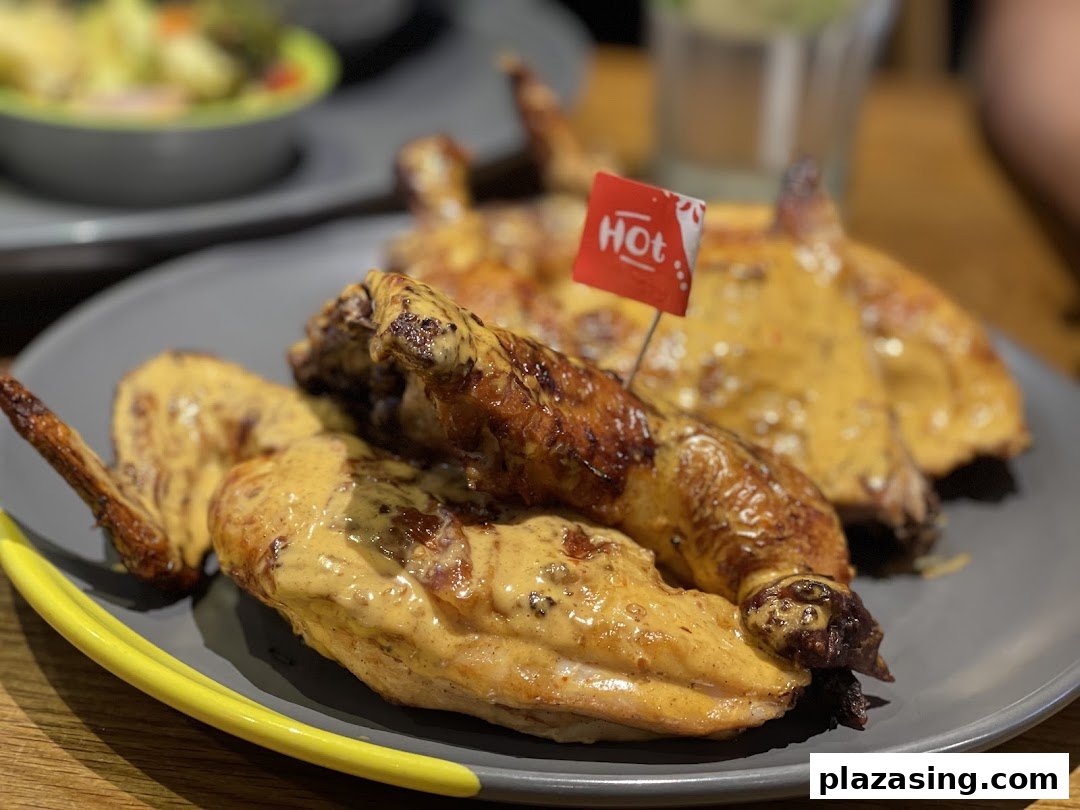 Close-up of Nando's flame-grilled PERi-PERi chicken with a 'Hot' spice flag.