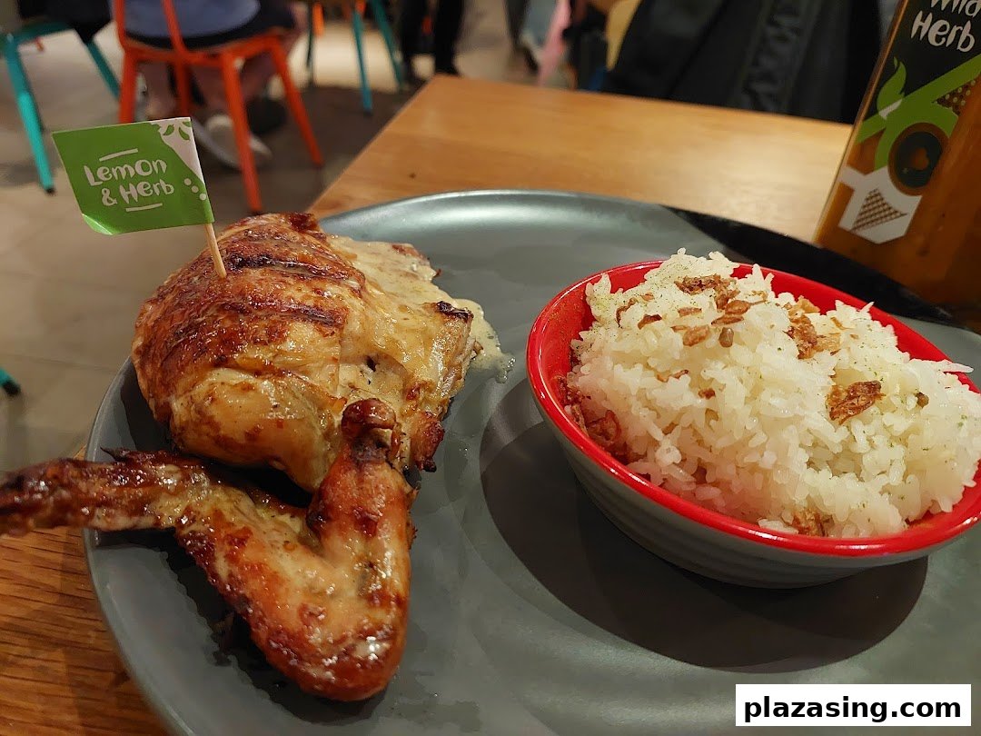 A plate of Nando's flame-grilled PERi-PERi chicken with Lemon & Herb flavor and a side of rice.